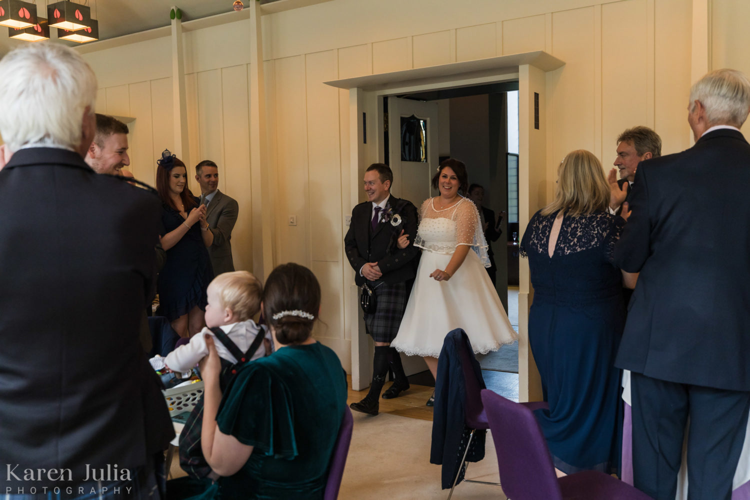 bride and groom enter the music room for the wedding breakfast