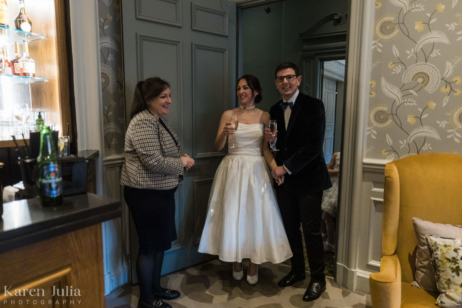 bride and groom entering the drinks reception room after the wedding ceremony