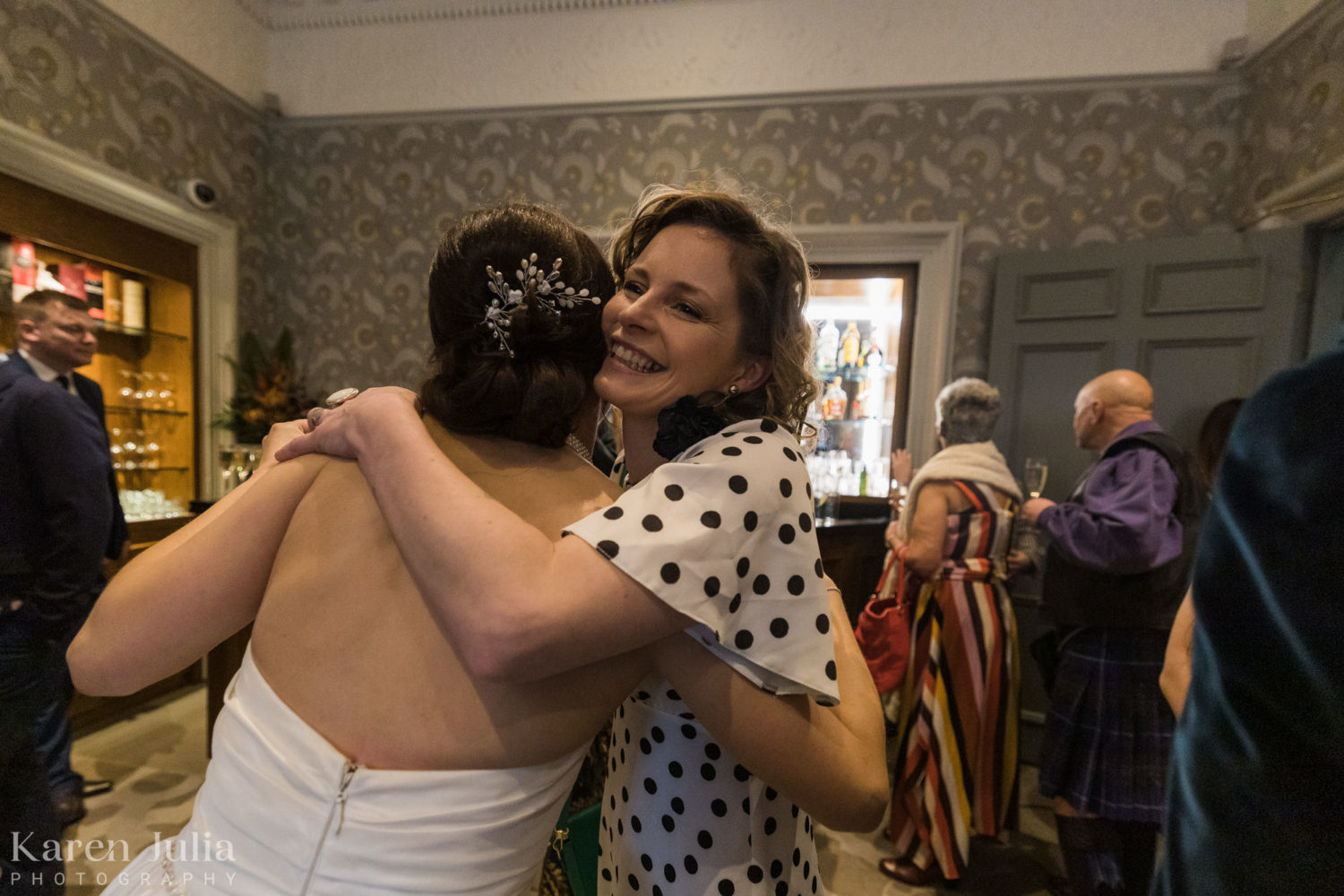bride embracing guests during the drinks reception