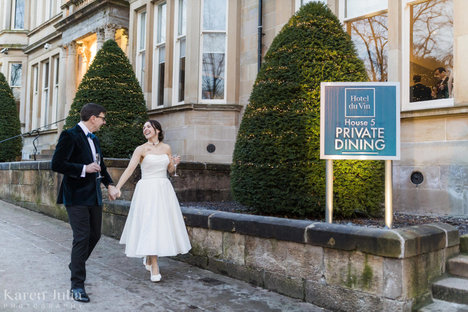 bride and groom walking together on their wedding day outside One Devonshire Gardens