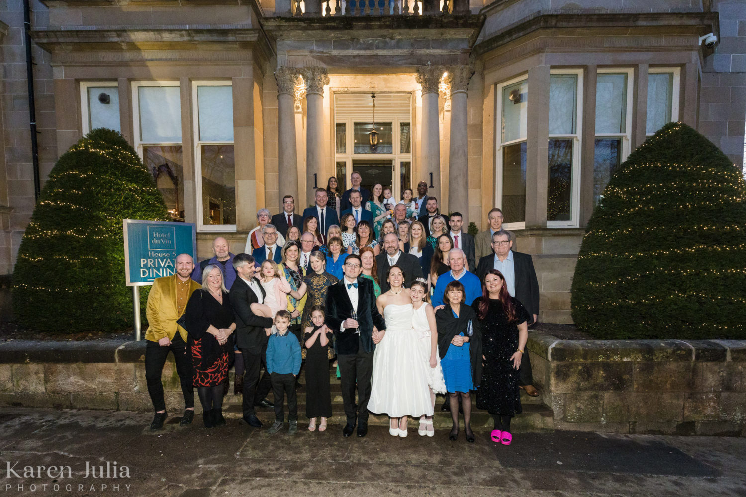 group photo of everyone on the stairs outside One Devonshire Gardens