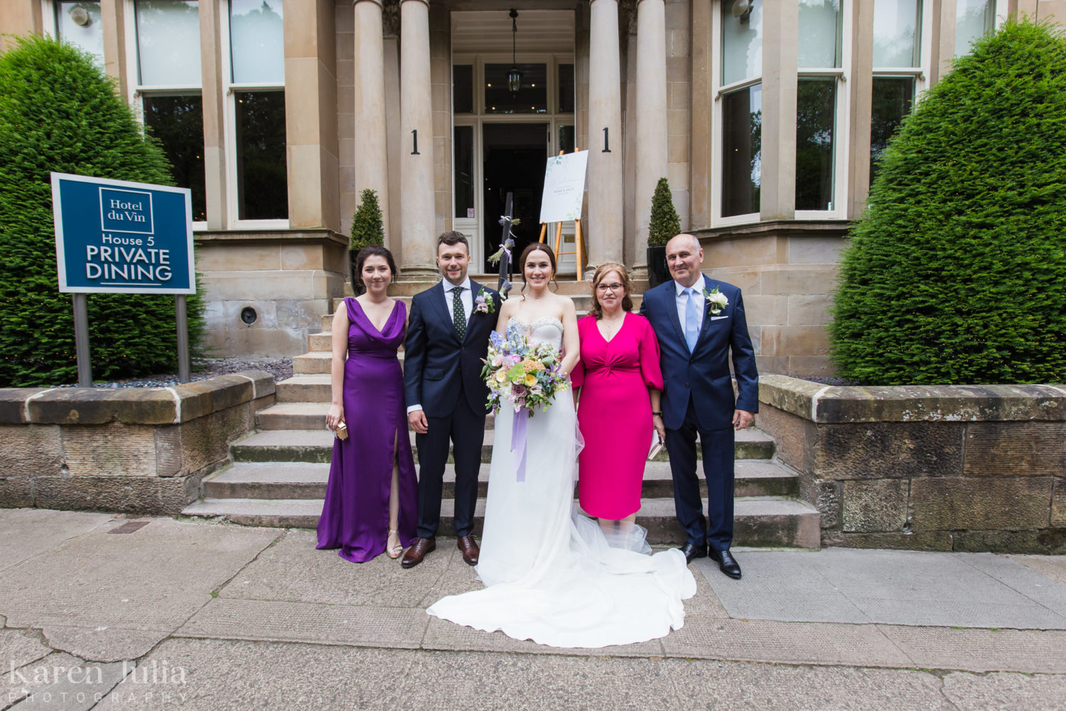wedding group photo with family on the stairs at One Devonshire Gardens