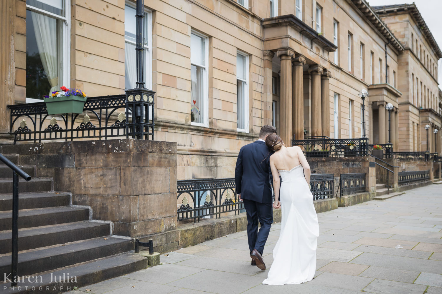 bride and groom walking together along Great Western Terrace