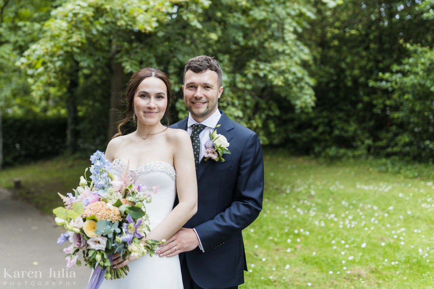 bride and groom portrait in the green space next to Great Western Terrace