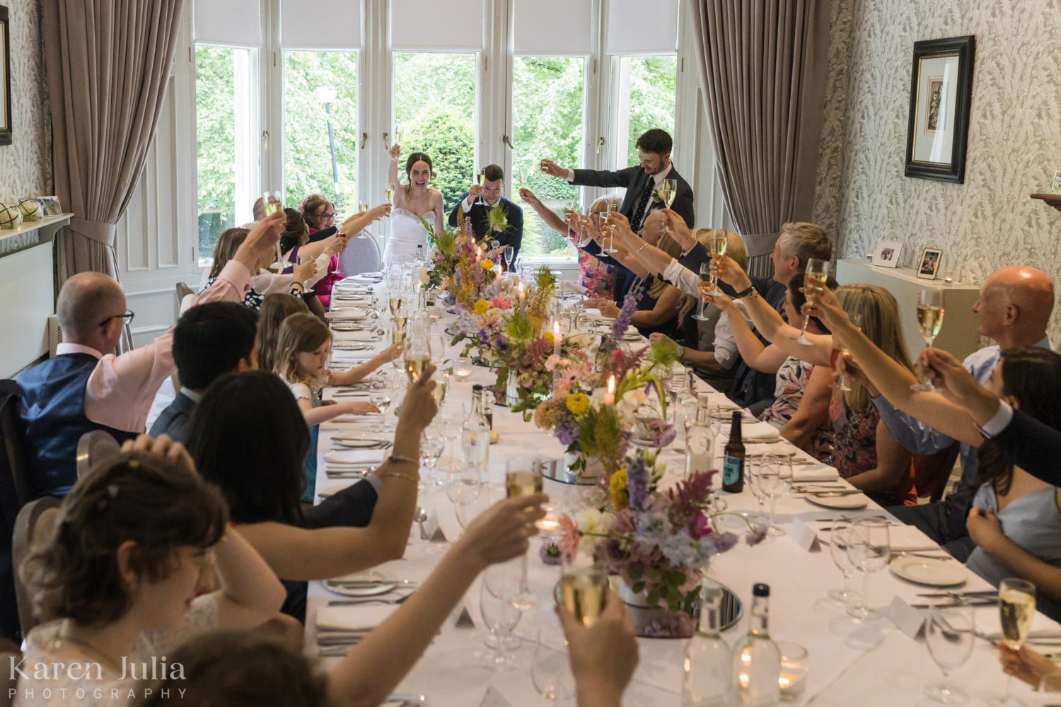 the couple and their guests raise glasses as a final toast