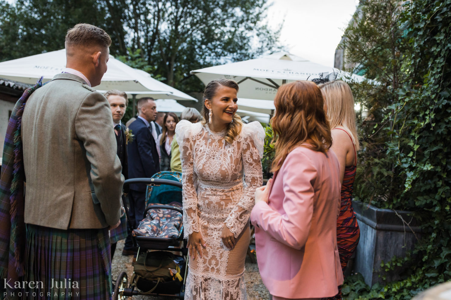 bride and groom chatting with guests during wedding reception in the Bothy garden