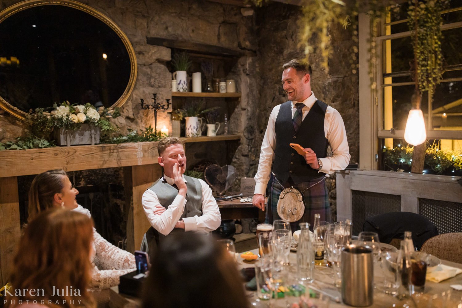 best man makes a speech to the wedding party in the Scullery