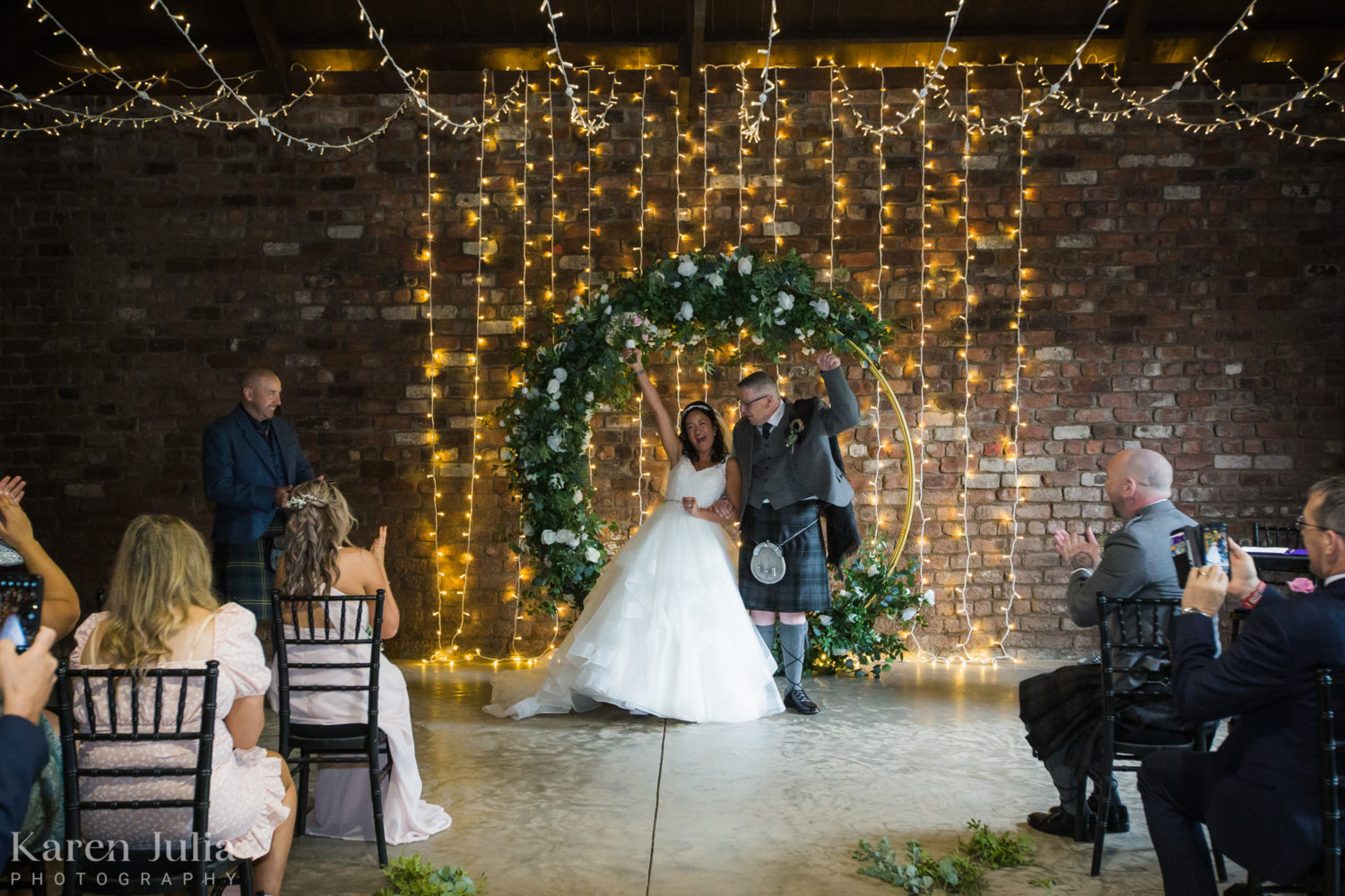 bride and groom celebrate after their wedding ceremony in the Engine Works