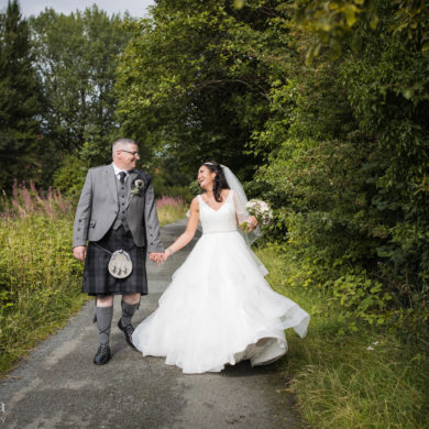 bride and groom walk along the canalside path at the Engine Works on their wedding day
