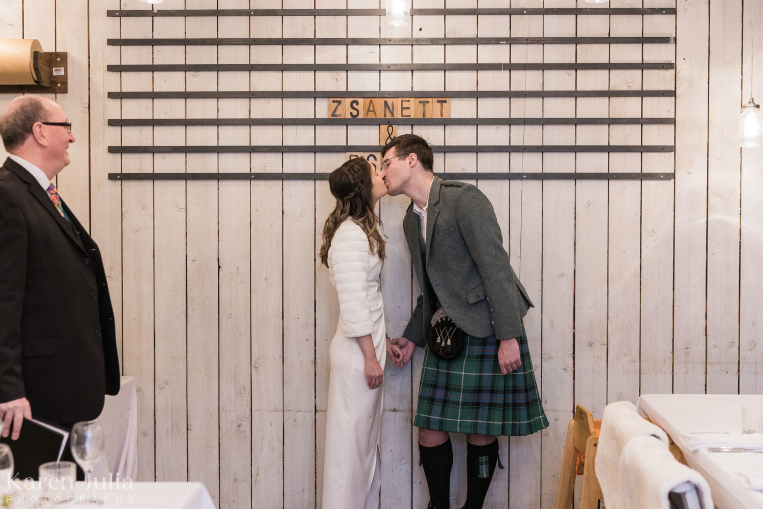 bride and groom share a kiss during their wedding ceremony