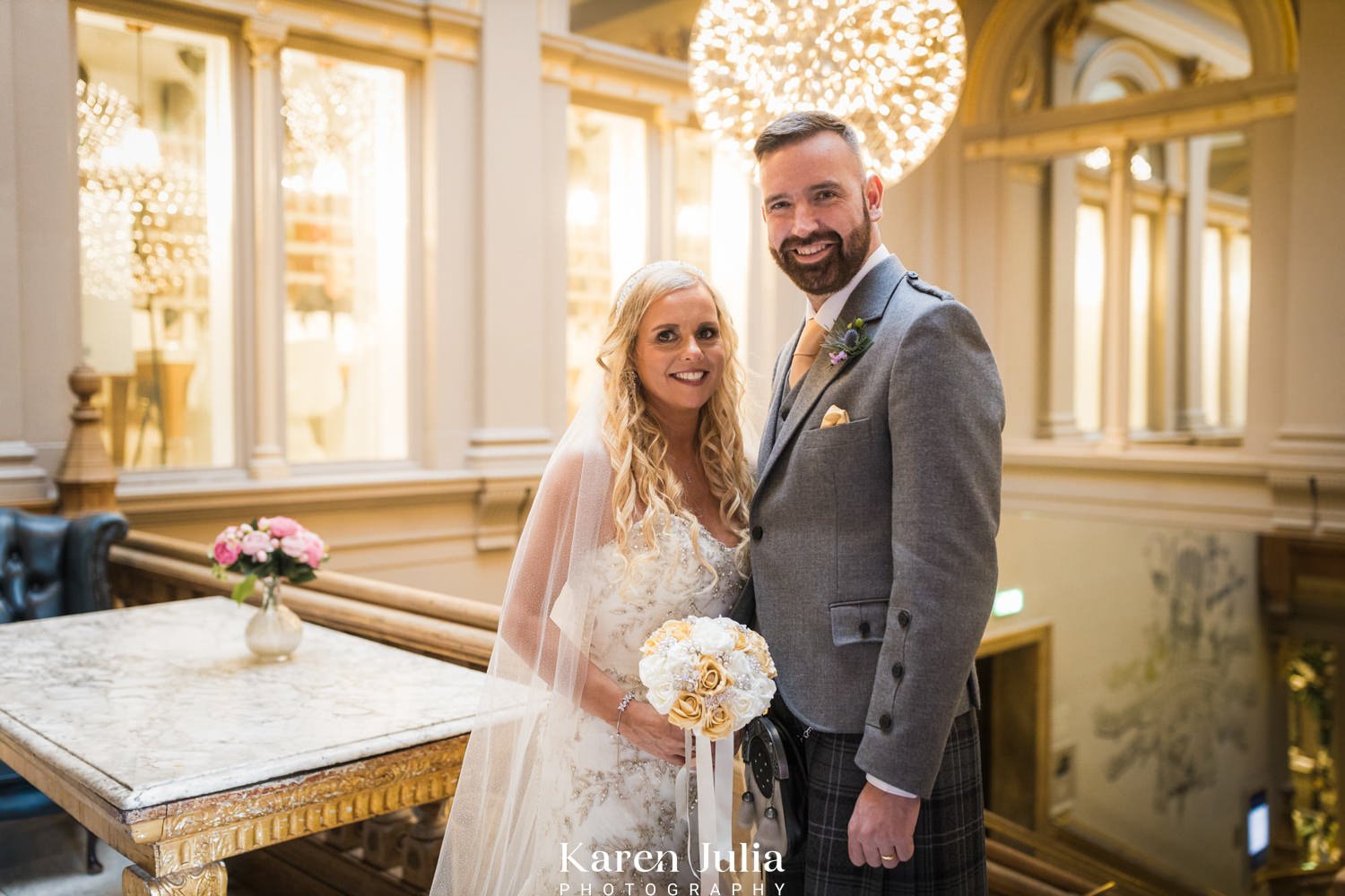 bride and groom portrait on the grand stairway inside The Corinthian Club