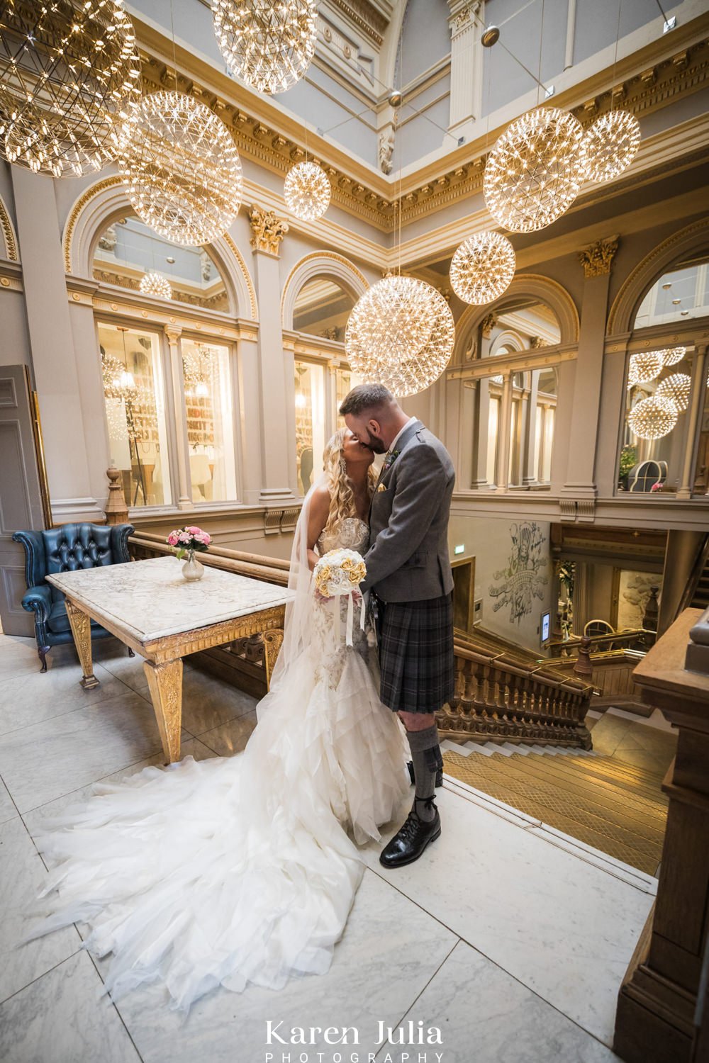 bride and groom portrait on the grand stairway inside The Corinthian Club