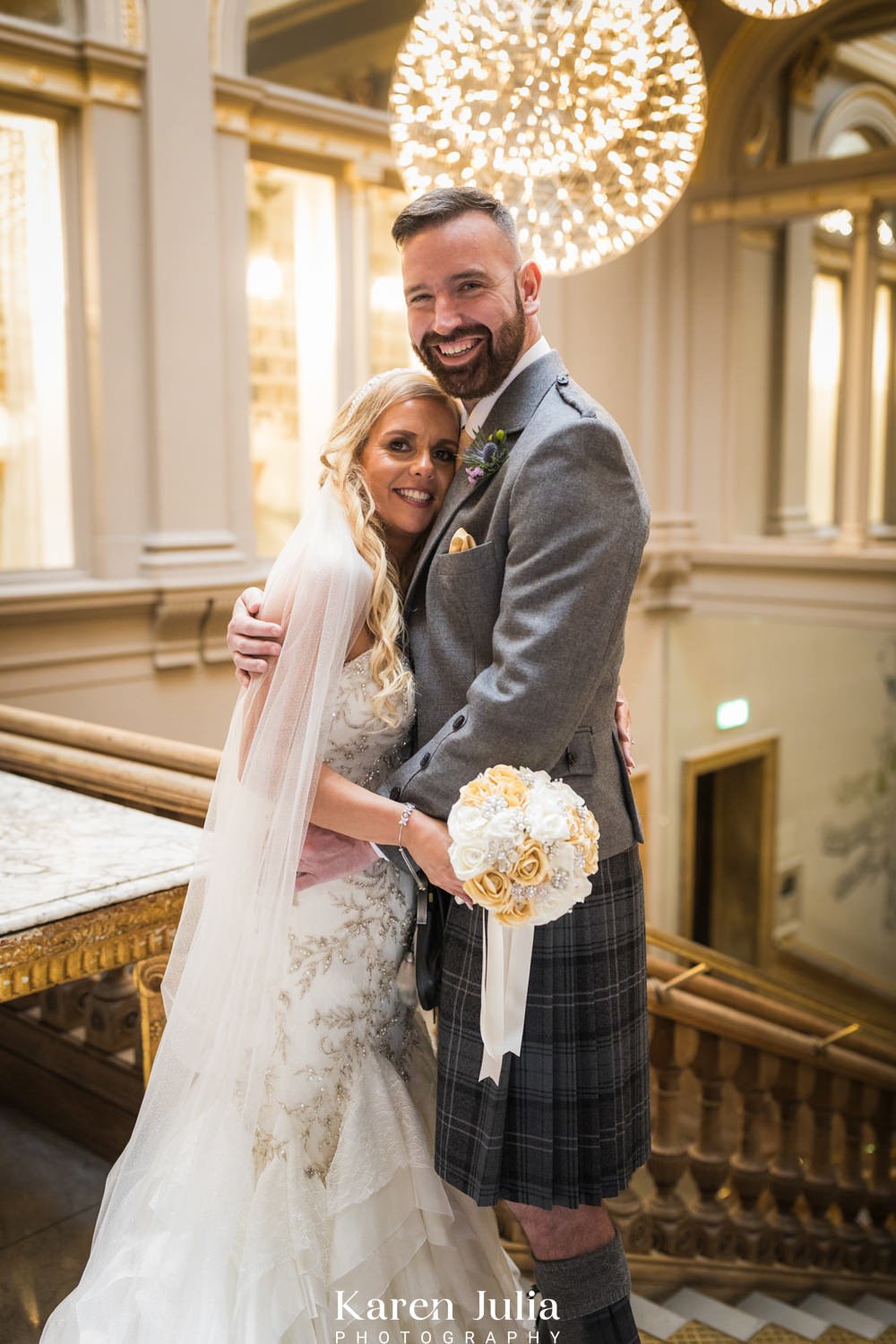 bride and groom portrait on the grand stairway inside The Corinthian Club