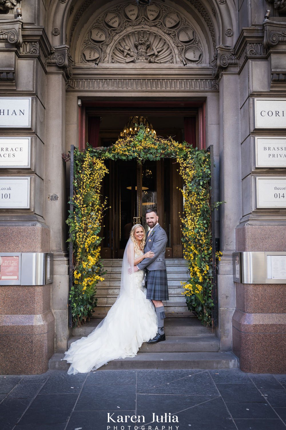 bride and groom portrait at the entrance of The Corinthian Club