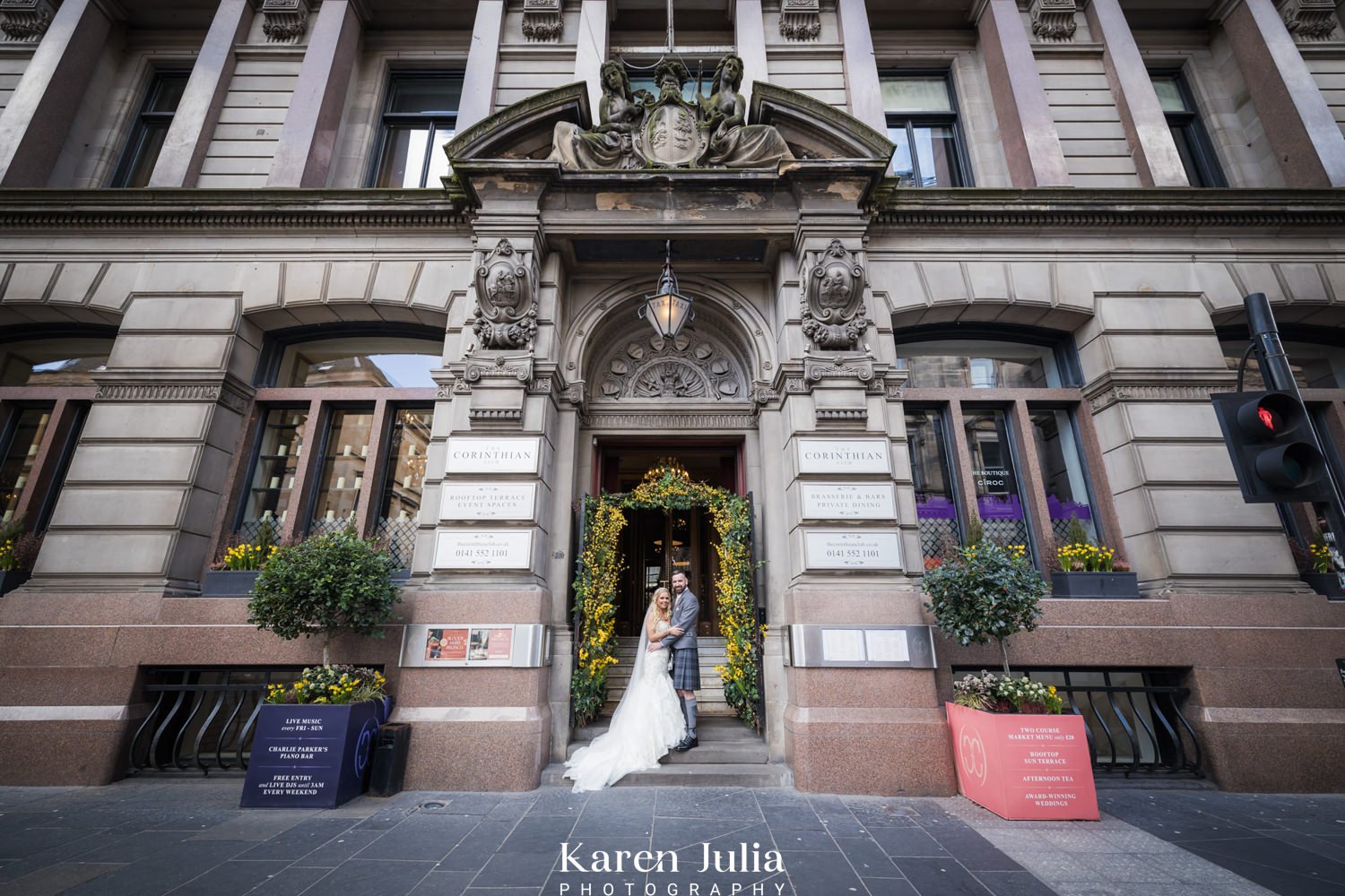 bride and groom portrait at the entrance of The Corinthian Club on their wedding day