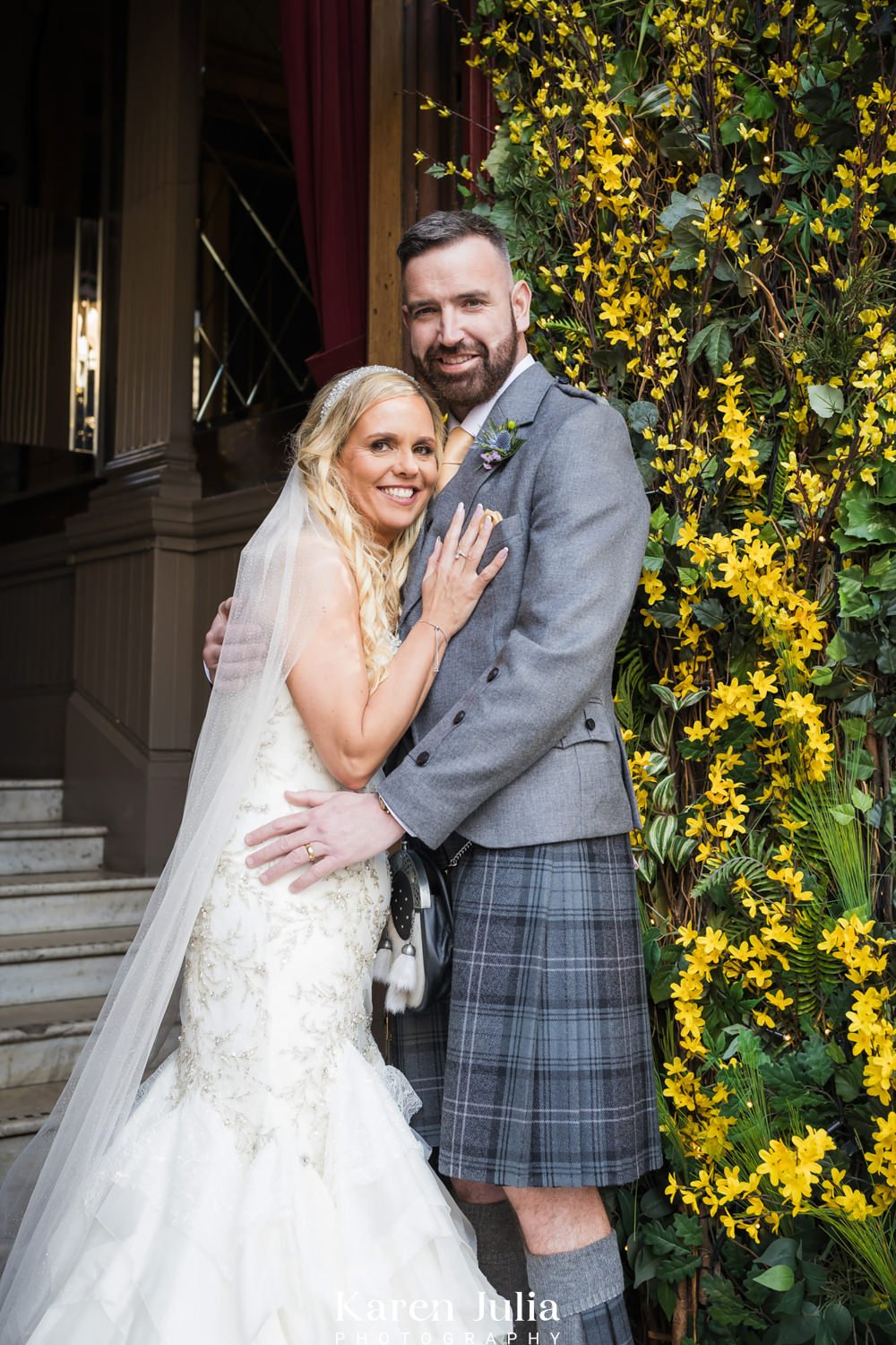 bride and groom portrait at the entrance of The Corinthian Club