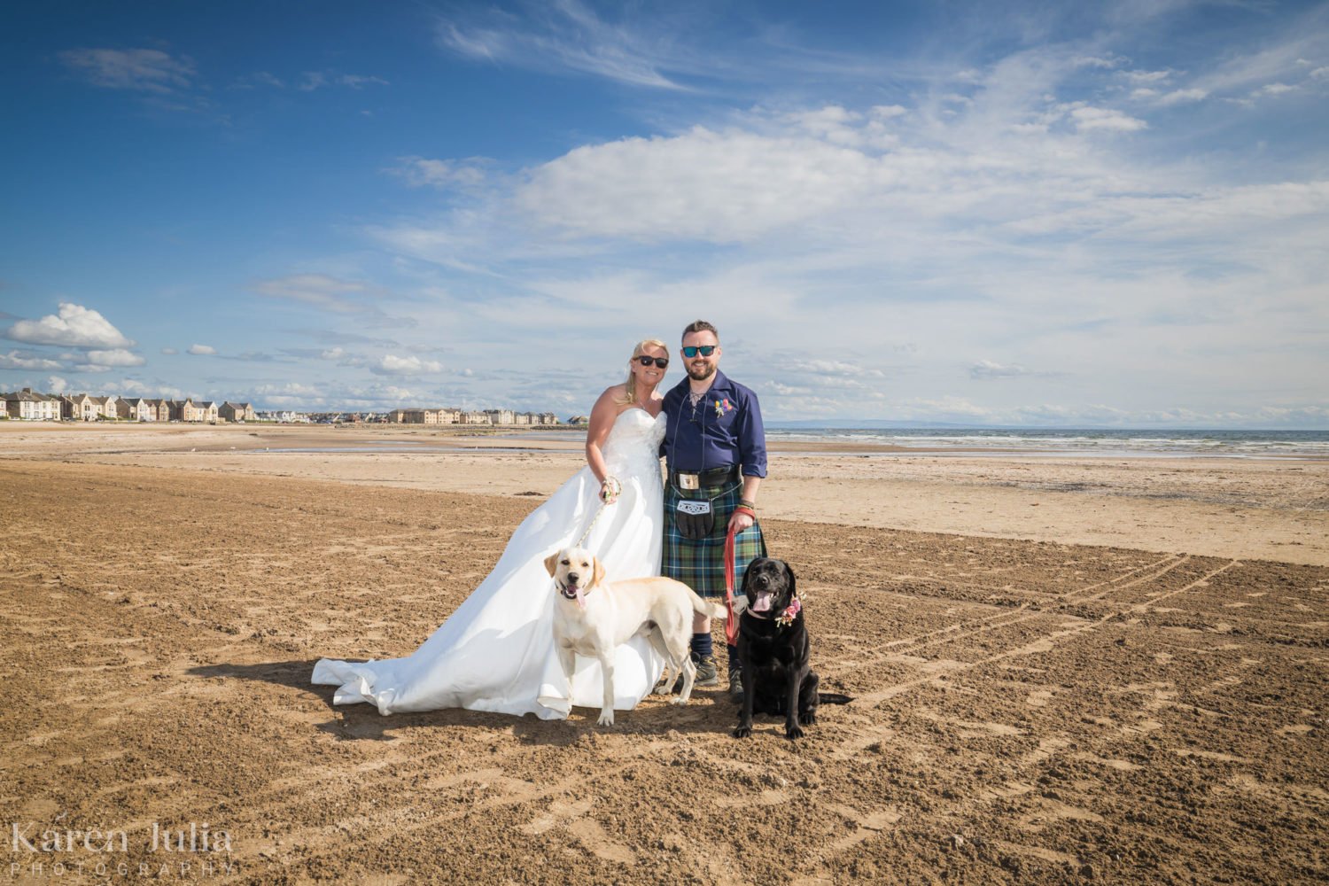 bride and groom with their two labrador dogs during their couple portraits