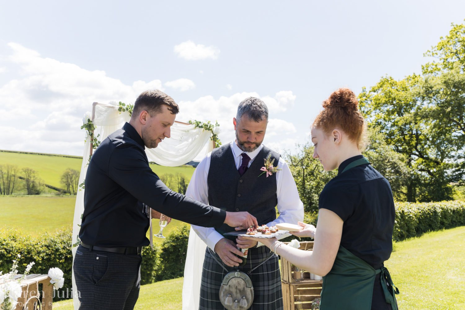 wedding guests enjoy canapés in the sun