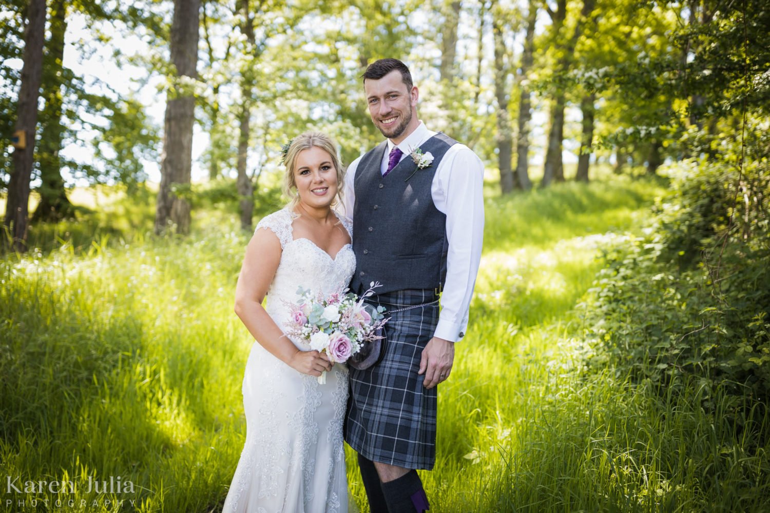 bride and groom smiling in the sun during their couple portrait session at Barwheys