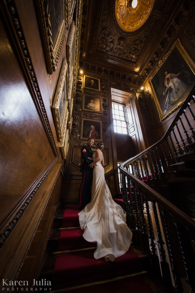 bride and groom embrace on the stairs inside the castle during their elopement photography