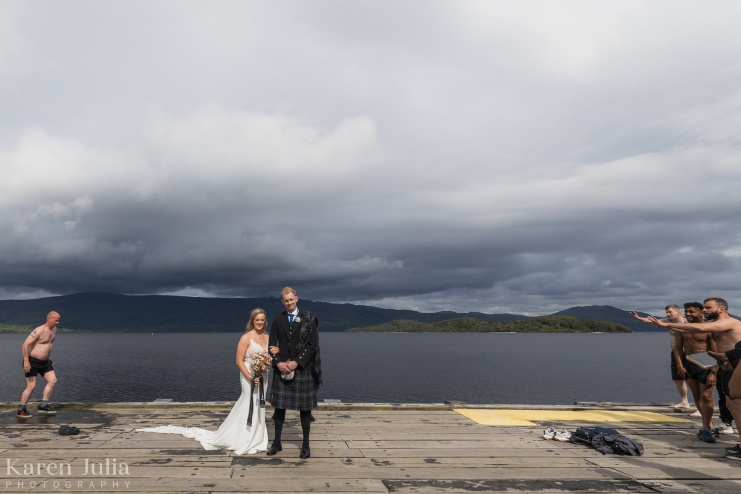bride and groom portrait at Luss Point with swimmers in the shot