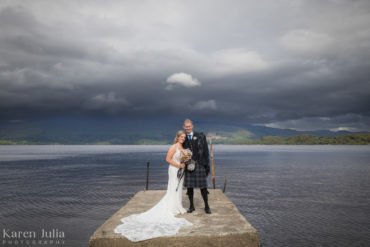 bride and groom on the pier near Luss beach in Loch Lomond.