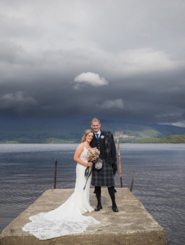 bride and groom on the pier near Luss beach in Loch Lomond.