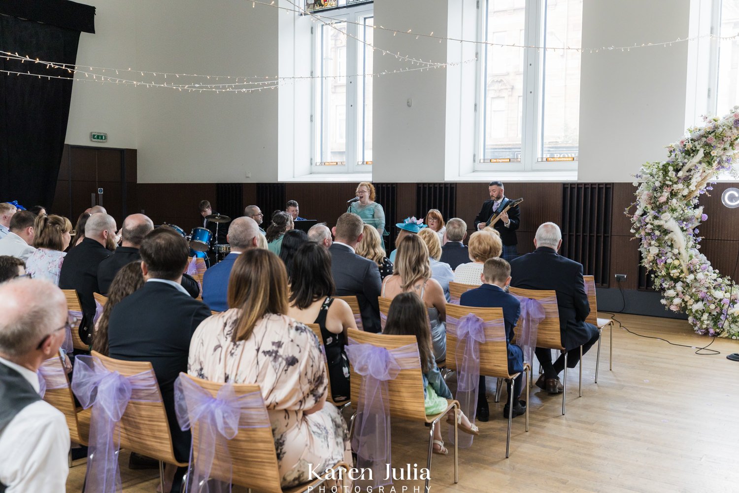 guests watch bride and groom perform a piece of music