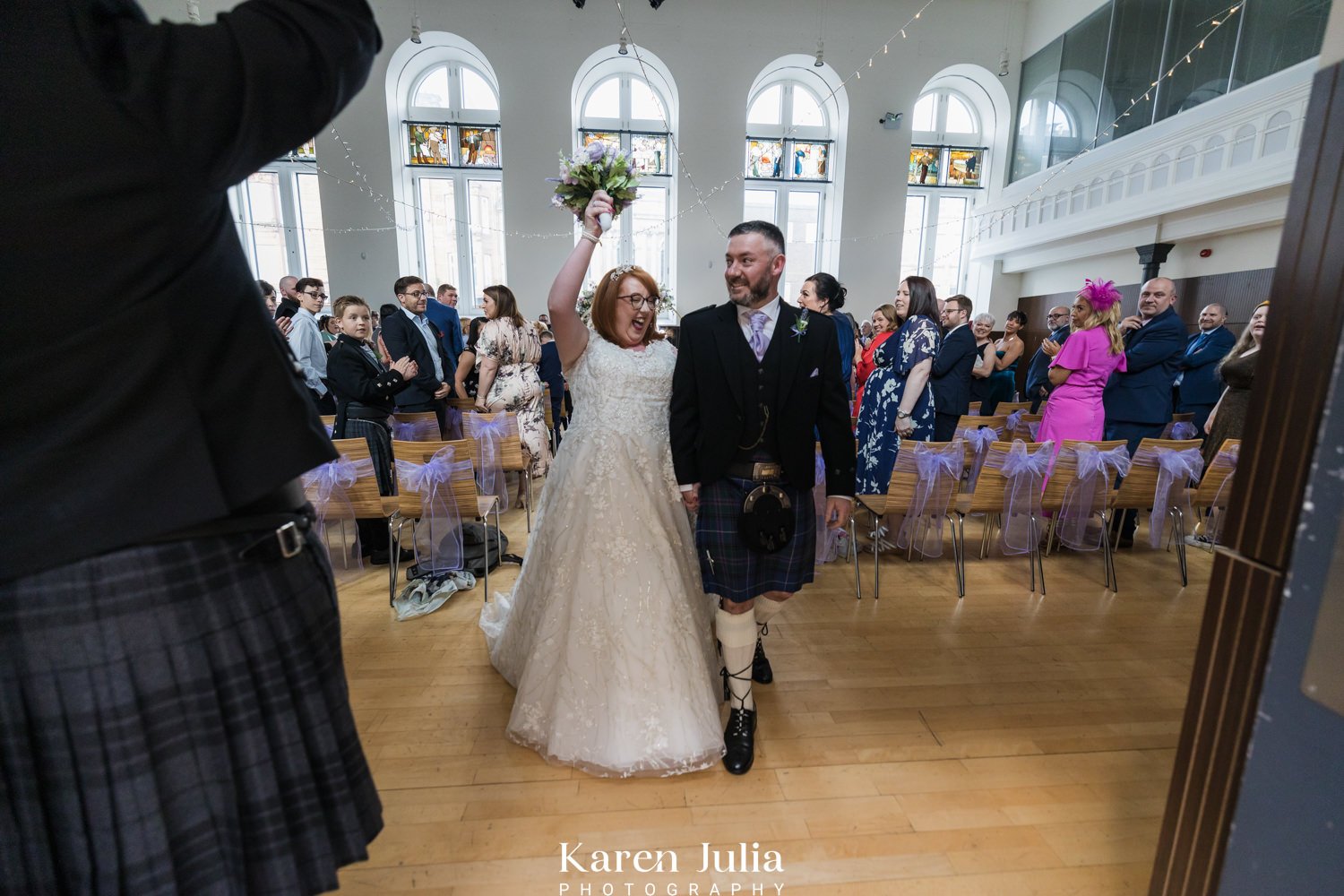 beide waves bouquet in the air in celebration of getting married