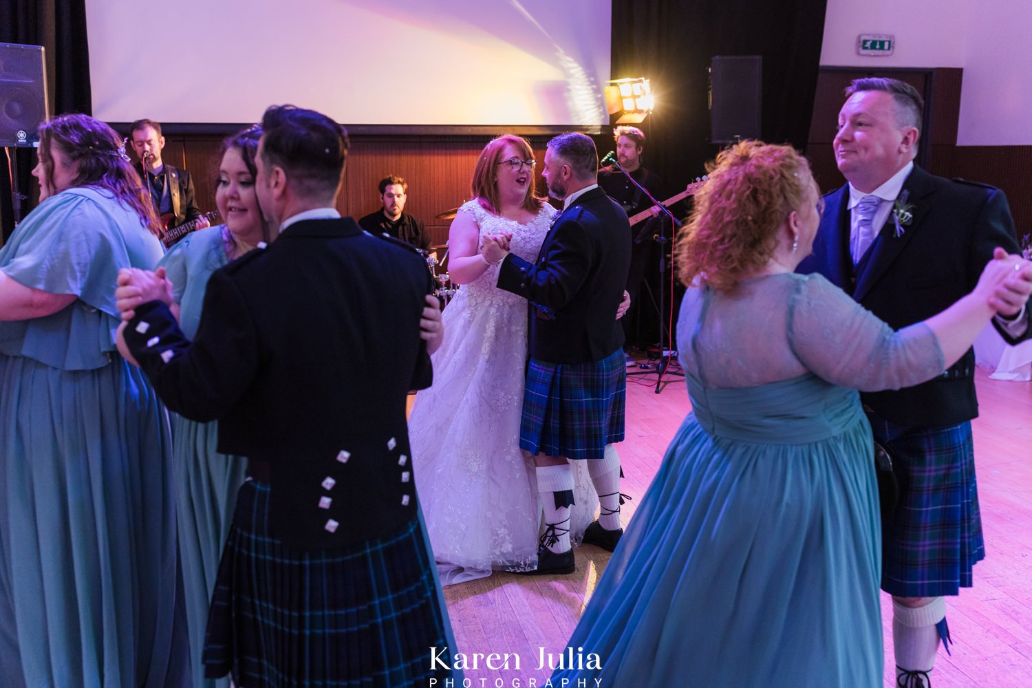 guests and couple dancing during the evening wedding reception