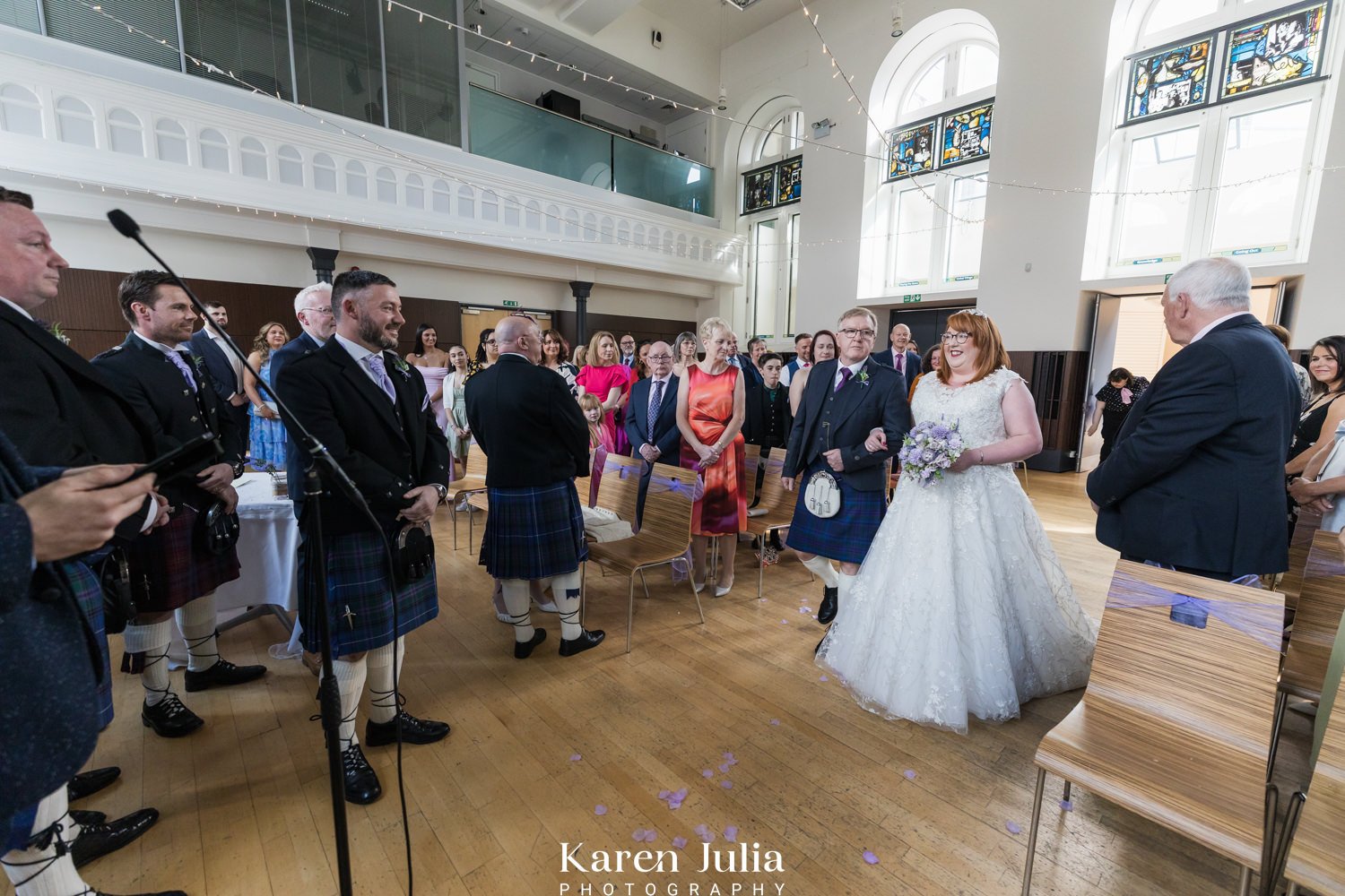 bride walks down the aisle to meet groom