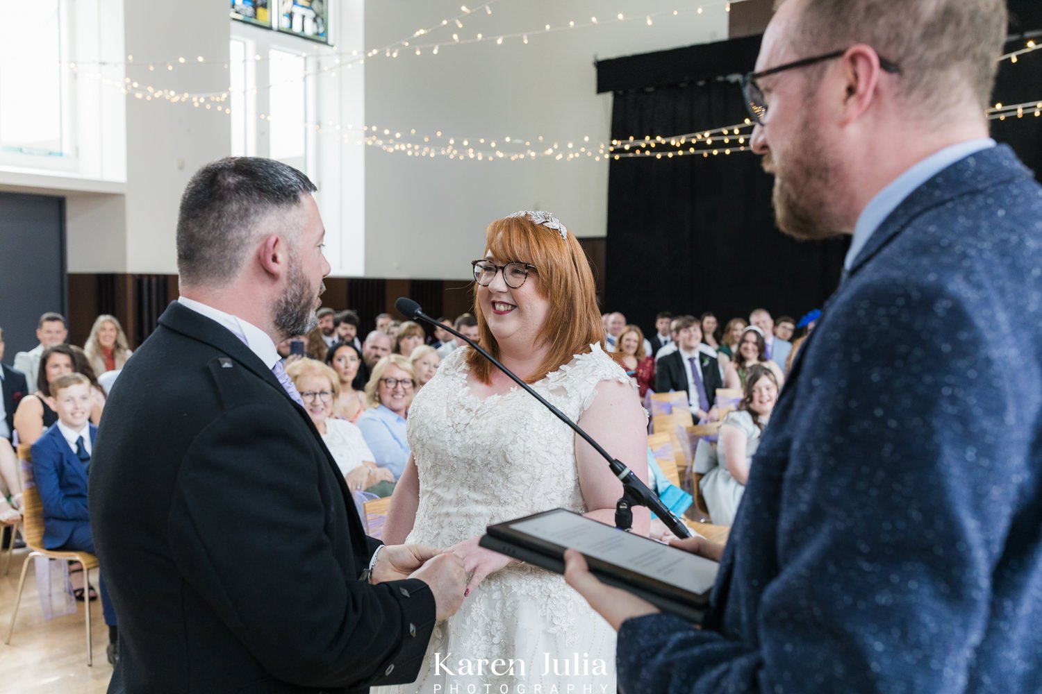 bride and groom exchange wedding rings