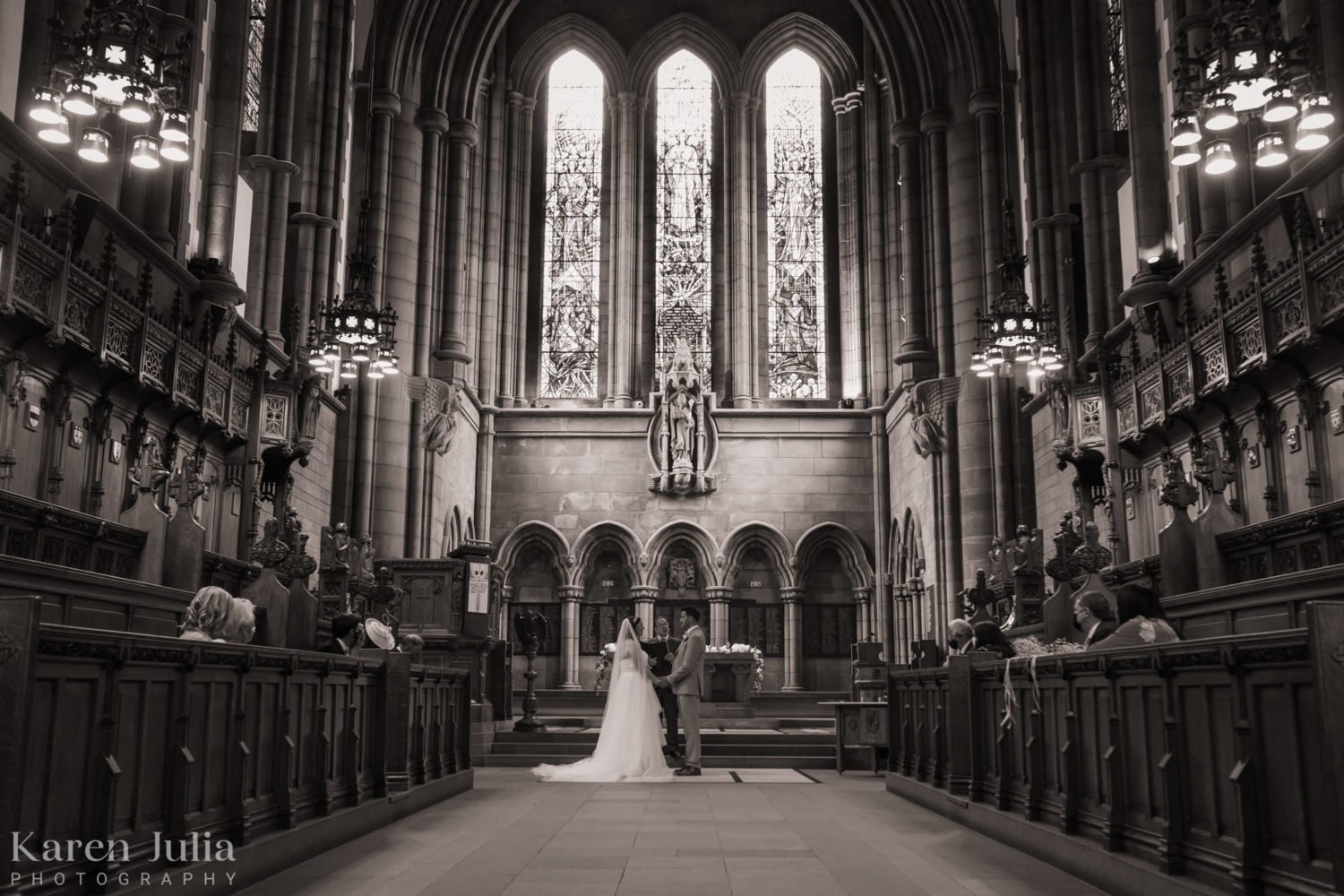 bride and groom exchanging vows on their wedding day in the univerity's memorial chapel