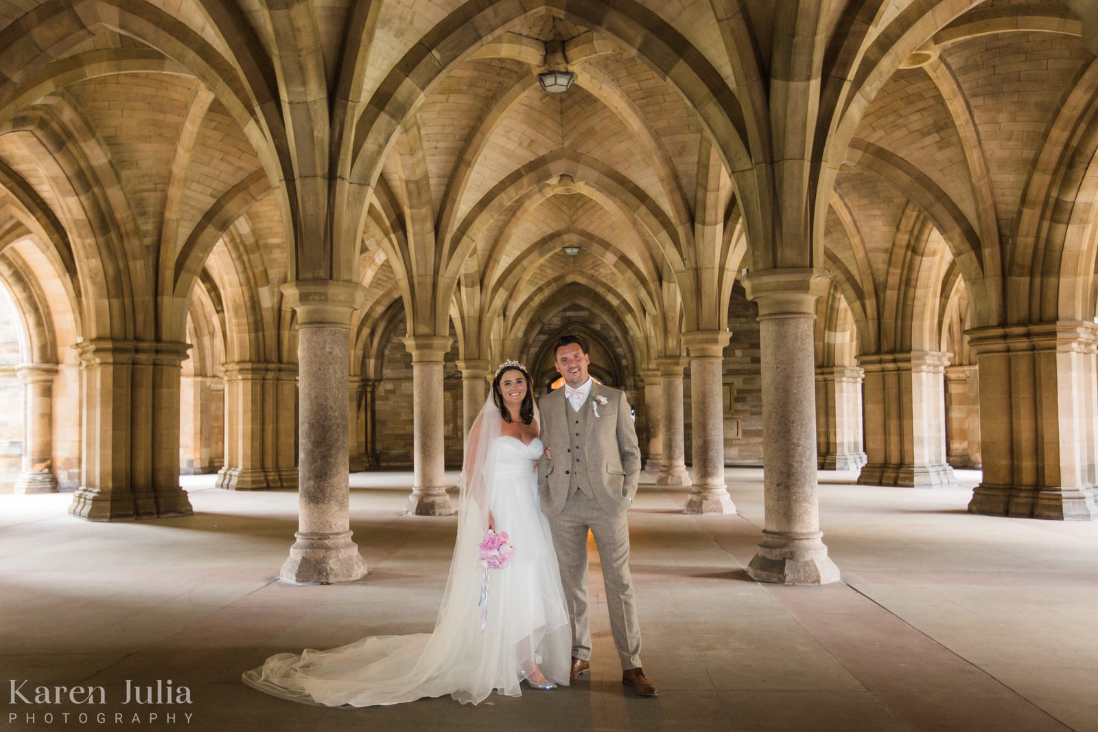 bride and groom in the cloisters during their university of Glasgow wedding photography