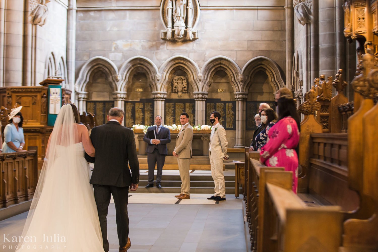 groom sees his bride as she walks down the aisle to meet him at University of Glasgow Memorial Chapel
