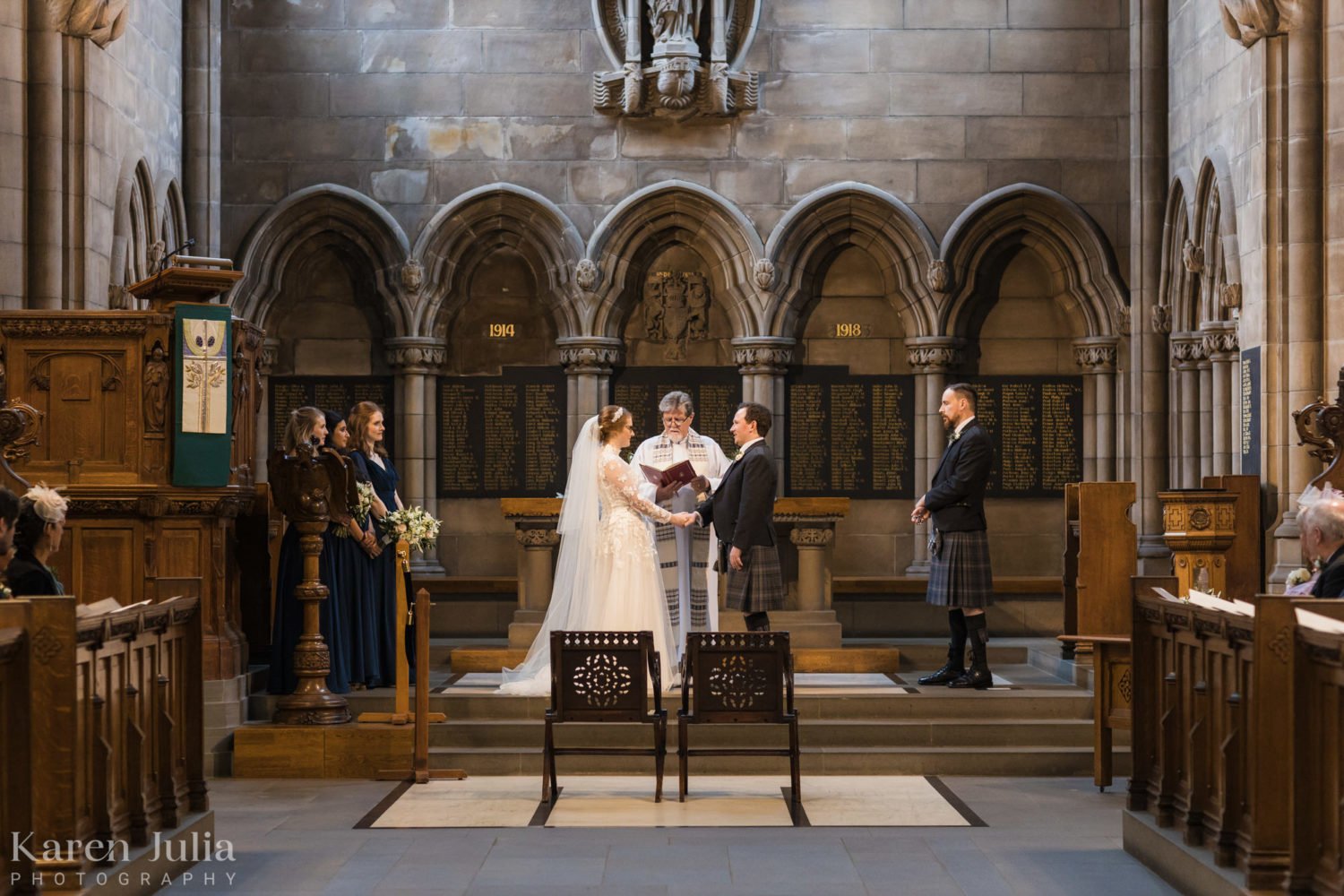 bride and groom exchange vows during their wedding ceremony in the University Memorial Chapel