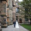 bride and groom walking together at Glasgow University