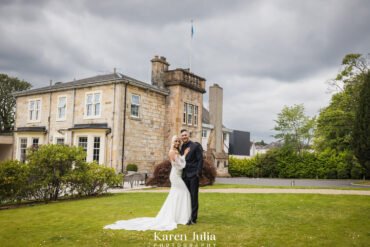 bride and groom portrait in front of Dalmeny Park House Hotel on their wedding day