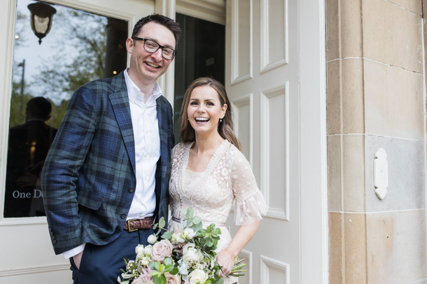 bride and groom portrait at entrance of One Devonshire Gardens