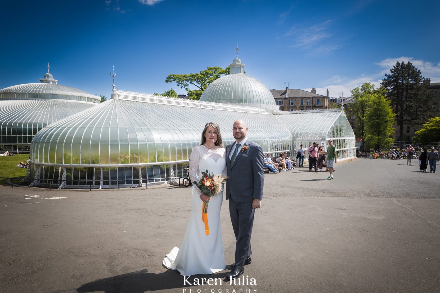 bride and groom standing outside Kibble Palace in Glasgow Botanic Gardens